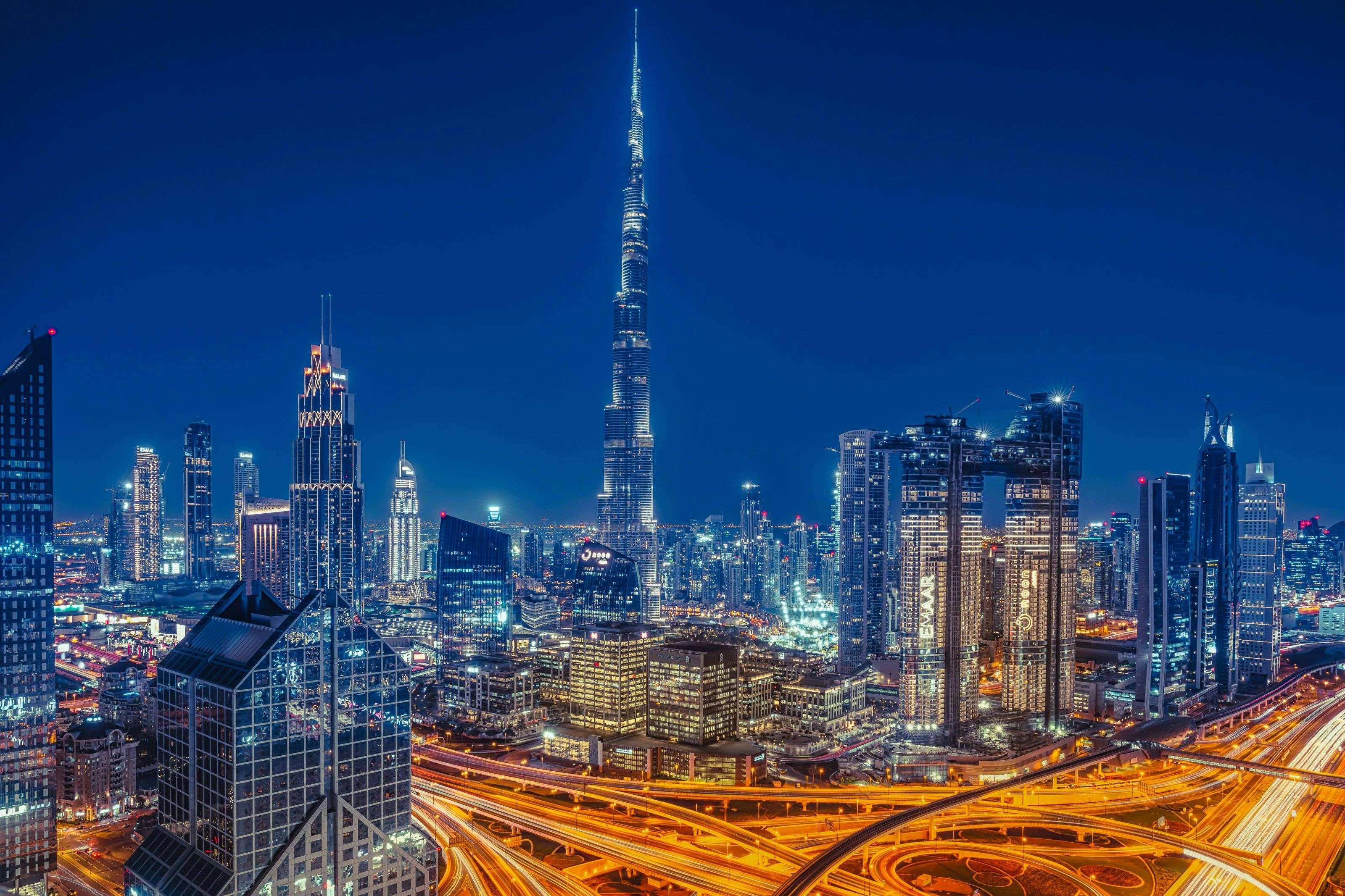Dubai nighttime skyline with Burj Khalifa and illuminated business district
